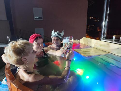 a group of people in a swimming pool at night at Miuti Residence in Triberg