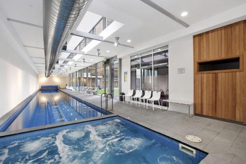 a swimming pool in a building with a pool at WOW Apartment on Swanston in Melbourne