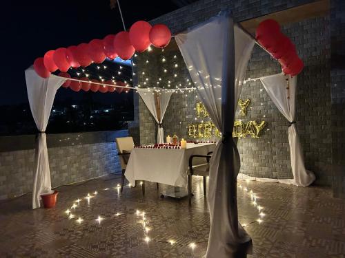 a table with white drapes and a table with lights at Hotel Sand Heaven in Port Blair