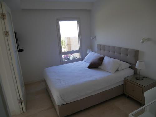 a bedroom with a white bed with a window at Shoresh mountain in Shoresh