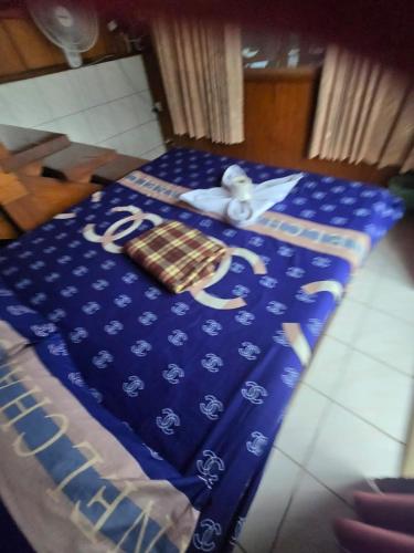a table with a blue table cloth with a nautical at Sunny house hostel in Pai