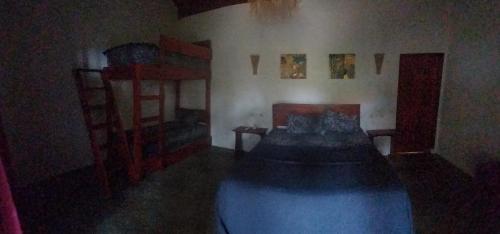 a dark room with a bed and a shelf at Kambuna Bungalow in Krui