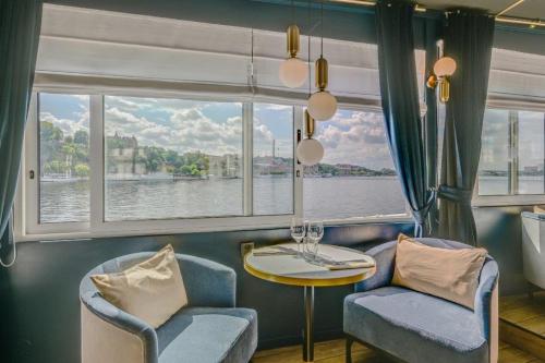 a room with a table and chairs and a window at Mälardrottningen Yacht Hotel in Stockholm