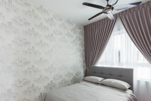 a bedroom with a bed and a ceiling fan at NaiBnB in Impiria Residensi in Klang
