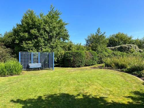 a park with a bench in the middle of a field at Ballinakill Lodge in Moyard