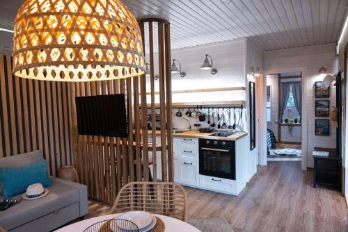 a kitchen and living room with a large chandelier at Bella Casa in Agia Triada