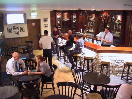 a group of people sitting at tables in a bar at Beacon View Lodge in Lancashire in Longridge