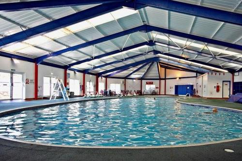a large swimming pool with people in it at Beacon View Lodge in Lancashire in Longridge