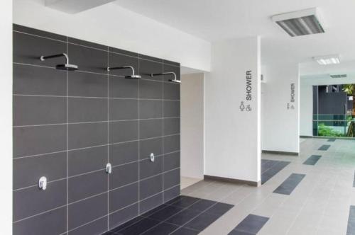 a room with a wall with gray tiles at NaiBnB in Impiria Residensi in Klang