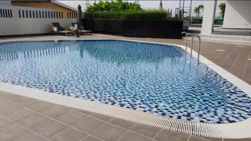 a large swimming pool with blue tiles in a building at Lazy Cozy Summer Afternoon Healing Daily Life in Klang