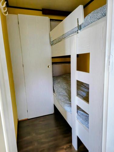 a bedroom with a bunk bed in a room at Chalet V31 in Makkum