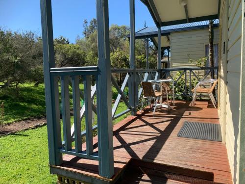 a porch with a green railing on a house at Beach Park Phillip Island - Cabins in Cowes