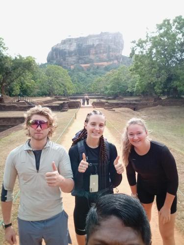a group of people giving the thumbs up while standing in front at SIGIRI HUNTER'S HOMESTAY & Hostel in Sigiriya