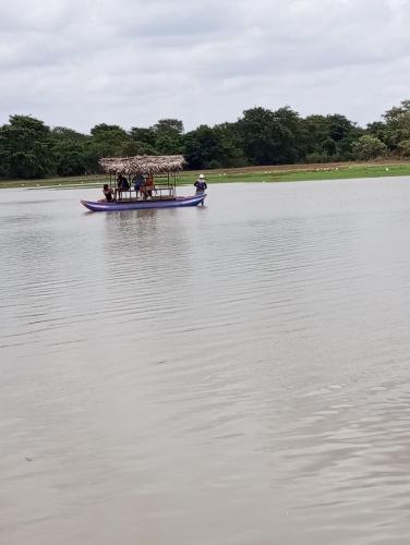 a group of people in a boat on a lake at SIGIRI HUNTER'S HOMESTAY & Hostel in Sigiriya