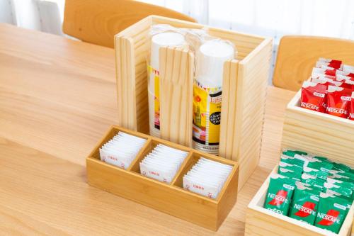 a wooden table with a tray of white plates at Kyoto Waka Hotel in Kyoto