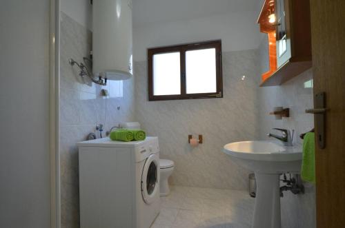 a bathroom with a washing machine and a sink at Apartment Kuftic - Relax Zone - Quiet Street in Rovinj