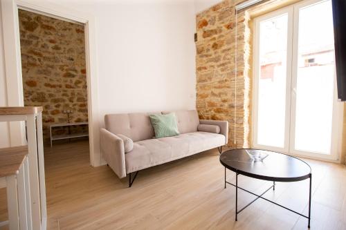a living room with a couch and a glass table at Colón 29 Apartments in Denia