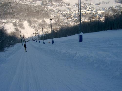 a person skiing down a snow covered ski slope at Pension Mikulka in Mikulov v Krušných Horách