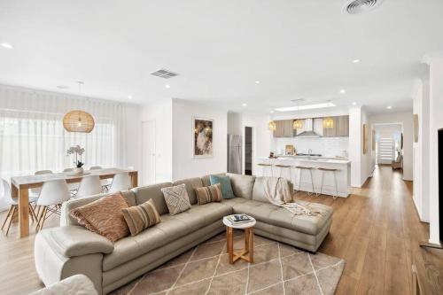 a living room with a couch and a kitchen at Modern Seaside Escape on the Coast in Ocean Grove