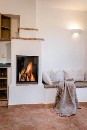 a living room with a fireplace with a couch at Möderlhof in Eggstätt