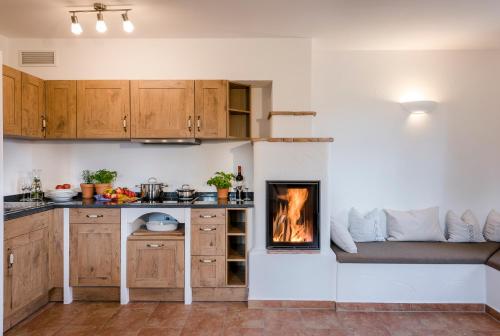 a kitchen with a fireplace in the corner of a room at Möderlhof in Eggstätt