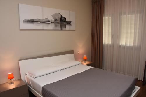 a woman laying on a bed in a bedroom at Residence Nazionale Matera in Matera