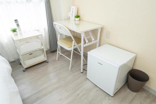 a room with a desk and a table and a chair at Kyoto Waka Hotel in Kyoto