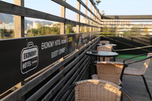 a row of tables and chairs on a bench at Economy Hotel Incheon Bupyeong Branch in Incheon