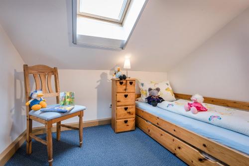 a bedroom with a bed and a chair and a window at Möderlhof in Eggstätt