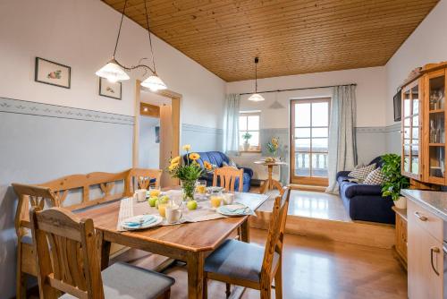 a kitchen and living room with a wooden table and chairs at Möderlhof in Eggstätt