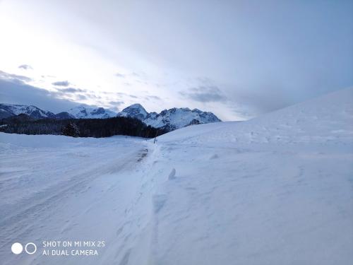 a person is skiing down a snow covered slope at Buttermilchalm in Sankt Martin am Tennengebirge