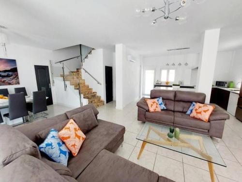 a living room with two couches and a dining room at Casa Palma by Rental Hero in Los Alcázares
