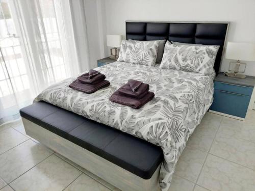 a bedroom with a large bed with two towels on it at Casa Palma by Rental Hero in Los Alcázares