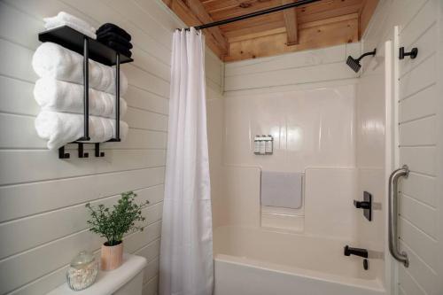 a bathroom with a shower with a shower curtain at Incredible Views l Family Friendly I Pool - Hot Tub in Sevierville