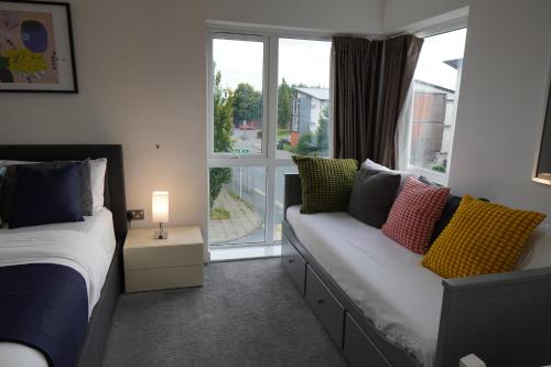 a bedroom with two beds and a window at Luxury Rooms - Pick a Room - Free Parking & Kitchen Access, Near Etihad Stadium, The Coop Live & Piccadilly Station, Manchester in Manchester