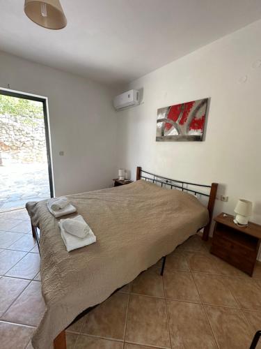 a bedroom with a large bed with two towels on it at Seapine Studios in Lassi