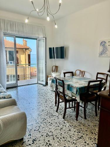 a dining room with a table and a view of the ocean at Casa Margherita in Ospedaletti