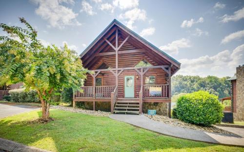 a log cabin with a porch and a tree at Heavenly Escape in Pigeon Forge