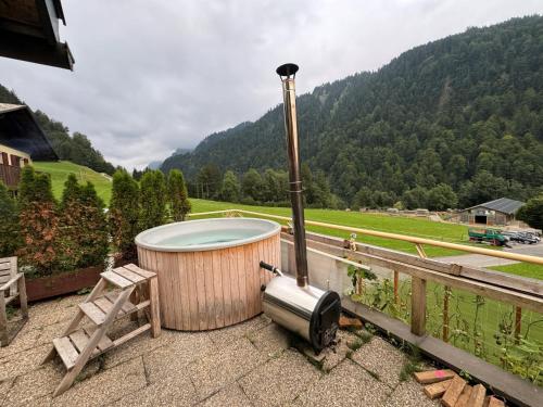 a hot tub sitting on top of a deck with a mountain at Freundliche 2-Zimmer-Erdgeschosswohnung mit Garten in Seeberg in Sonntag