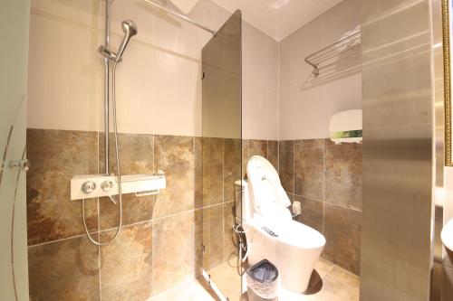 a bathroom with a toilet and a shower at Noble Muintel in Suncheon