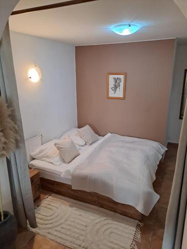 a bedroom with a large white bed in it at Apartman Romana in Poštorná
