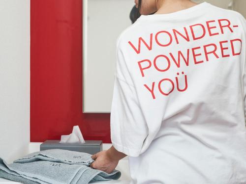 a woman wearing a shirt that says wonderpowered you at WPÜ HOTEL Shinjuku in Tokyo
