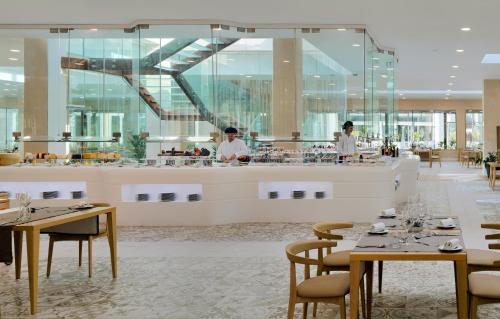 a restaurant with tables and people in the background at GF Victoria in Adeje