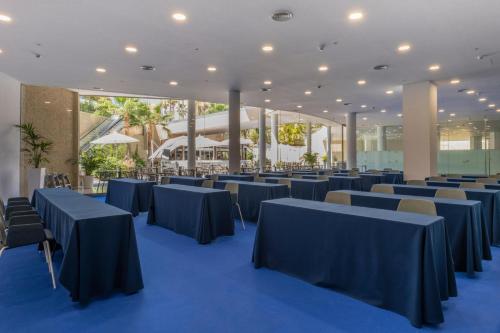 a banquet hall with blue tables and chairs at GF Victoria in Adeje