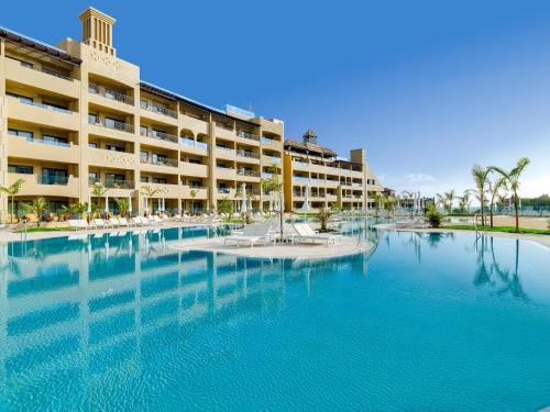 a hotel with a swimming pool in front of a building at GF Victoria in Adeje