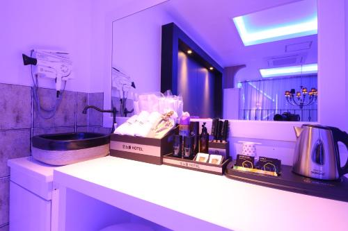 a bathroom with a counter with cosmetics and a mirror at Noble Muintel in Suncheon