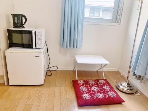 a microwave oven sitting on top of a refrigerator at JR t akadababa subway 5 mins walk! Newly building 新築! 高田馬場駅 徒歩圏内大人気! Shinjuku新宿圈!高速无限制Wi-FI BC in Tokyo