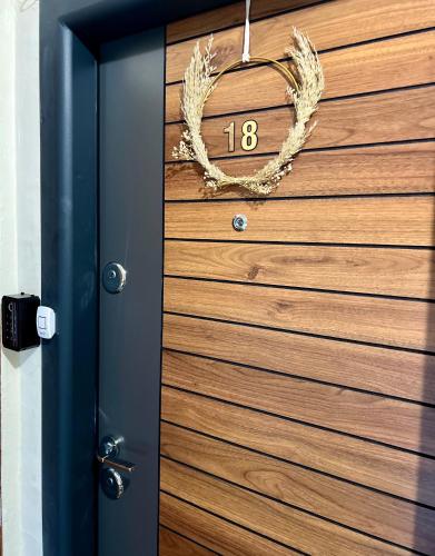 a door with areath on it with a number on it at Resita Dream Apartament in Reşiţa