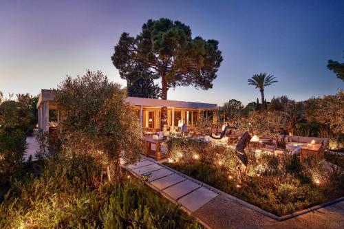 a house with a garden at night with lights at Ikos Olivia in Gerakini