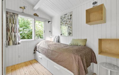 a bedroom with a bed and a window at Cozy Home In Jægerspris With Wifi in Jægerspris